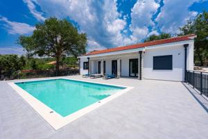 a villa with a swimming pool and a building at Villa Montenegrina in Krapina