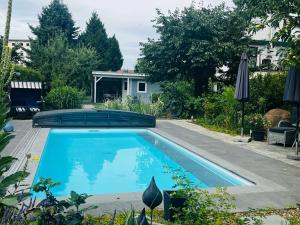 a swimming pool in the yard of a house at Elbidyll in Magdeburg