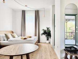 a living room with a couch and a table at Vita Serena in Gyenesdiás