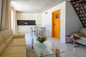 a living room with a couch and a table at Penzión Walter in Veľké Úľany