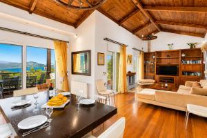 a kitchen and living room with a table and chairs at Villa Glan Y Mor in Elounda