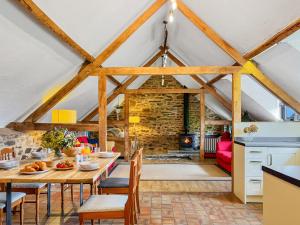 a kitchen and dining room with a table and chairs at Jasper Cottage Hawkridge in Dulverton