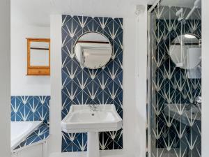 a bathroom with a sink and a mirror at Jasper Cottage Hawkridge in Dulverton +42 photos
