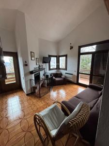 a living room with a couch and a chair at Dimora Ludovica in Selvino