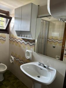 a bathroom with a sink and a mirror at Dimora Ludovica in Selvino +58 photos
