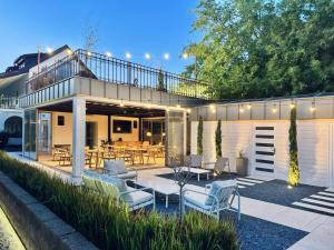 a house with a patio with a table and chairs at Vita Serena in Gyenesdiás