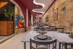 a dining room with tables and chairs in a restaurant at AFS LOFT HOSTEL Aracaju in Aracaju