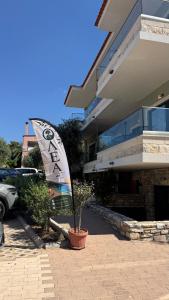 a sign in a pot in front of a building at Olea Apartments in Potos