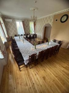a large dining room with a long table and chairs at Leču muiža in Lēči