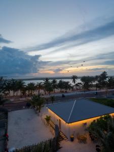 a building on the beach with a sunset in the background at Maako Retreats in Milandu +118 photos