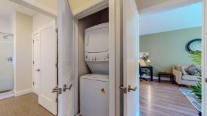 a hallway with a door open to a room with a refrigerator at Elegant Home in Stamford