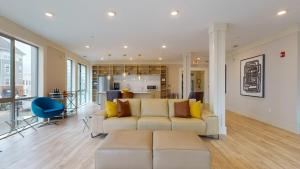 a living room with a couch and a kitchen at Elegant Home in Stamford