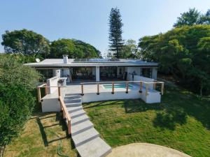 a house with a staircase leading up to it at First Light Serenity in Hluhluwe
