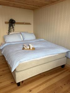 a bed in a bedroom with two cups on it at Bird Nest in Bømlo
