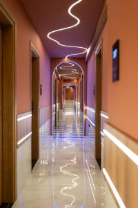 a hallway in a building with lights on the ceiling at ZOI Girni - Seaside Hotel in Olympic Beach
