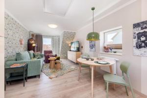 a living room with a couch and a table at Ferienwohnung Morgen am Meer in Sassnitz