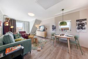 a living room with a couch and a table at Ferienwohnung Morgen am Meer in Sassnitz