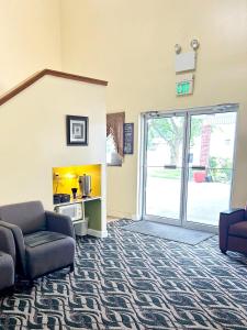 a living room with a couch and a sliding glass door at PATRIOT INN in Spencer