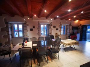 a living room with a dining room table and chairs at Villa Veli Palac in Baška +9 photos