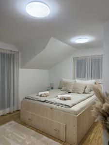 a bed in a white room with two dogs on it at Villa Mercurii in Sarajevo +43 photos