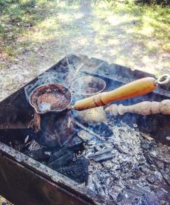 a bunch of cooking utensils on a grill at Lini Guest House in Nīca