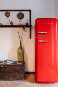 an old red refrigerator in a room with a vase at Casa La Terrazza in Vietri sul Mare