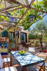a patio with a table with a bowl of fruit on it at Casa La Terrazza in Vietri sul Mare