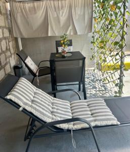 a chair with a table and a tableablish at Apartman Blue Moon Split- free parking in Split