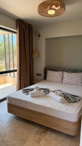 a bedroom with a bed with towels on it at Olea Village in Potos