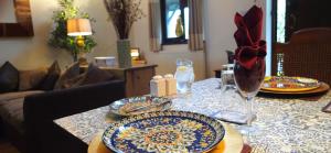 a table with plates and glasses on top of it at Miltons Apartments and Rooms in Langford