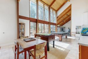 a living room with a table and pool tables at Lake Shore Drive in Franklin