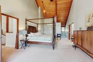 a bedroom with a canopy bed and a wooden ceiling at Lake Shore Drive in Franklin