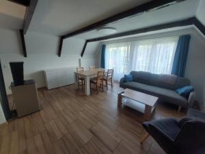 a living room with a blue couch and a table at Chata Kamenice in Kamenice