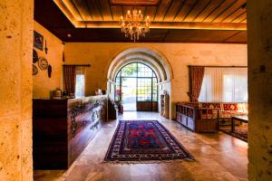 a living room with a chandelier and a large window at Empire Cave Cappadocia in Göreme
