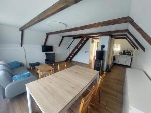 a living room with a wooden table and a couch at Chata Kamenice in Kamenice
