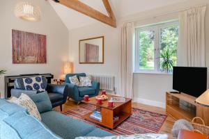 a living room with blue furniture and a tv at 2 Bed in Laxton oc-p44858 in Laxton