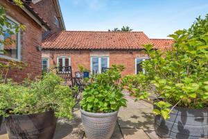a group of plants in large pots in front of a house at 2 Bed in Laxton oc-p44858 in Laxton