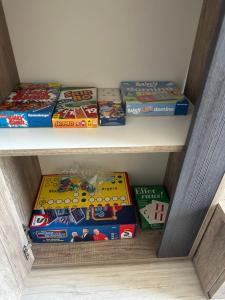 a bunch of lego games are sitting on a shelf at Rosenhaus Esens - Wohnung Backbord in Esens
