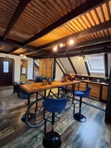 a room with a large wooden table and blue chairs at Casa Anne Boutique in Braşov
