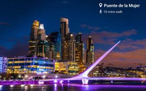 a view of a city at night with a bridge at Trendy Apartment in Puerto Madero in Buenos Aires