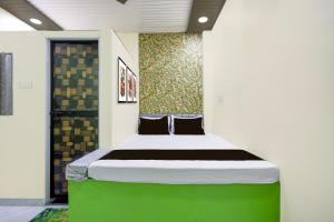 a bedroom with a large bed in a room at HOTEL O GUMTHI in Māharjhari
