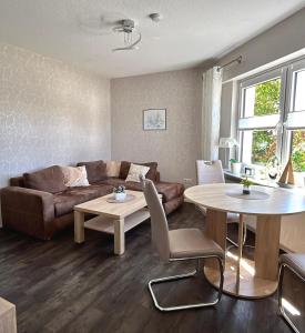 a living room with a couch and a table at Sommer Gästehaus in Bremerhaven