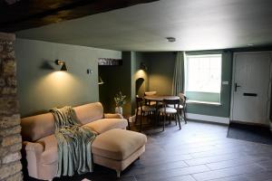 a living room with a couch and a table at Fuchsia Cottage - Accessible Comfort in Wilton