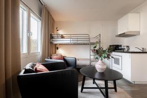 a small living room with a couch and a table at First Hotel Halmstad East in Halmstad