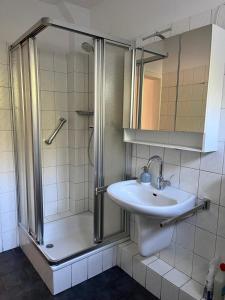 a bathroom with a sink and a shower at Sommer Gästehaus in Bremerhaven +6 photos