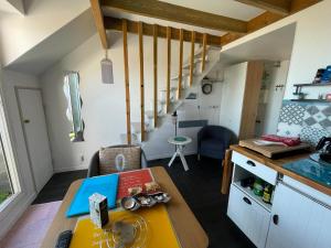 a small kitchen with a table in a tiny house at APPARTEMENT VUE PORT CROUESTY in Arzon
