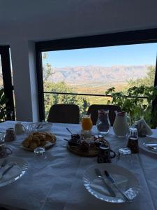 a table with plates of food on it with a view at Memo's GUEST house in Labova e Poshtme