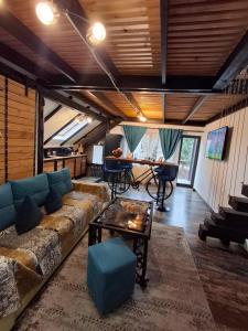 a living room with a couch and a table at Casa Anne Boutique in Braşov