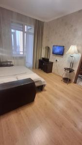 a large bedroom with a bed and a television at See4YOU in Odesa