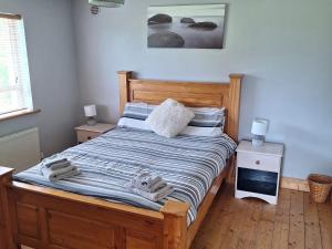 a bedroom with a bed with towels on it at 19 River Glen in Curracloe